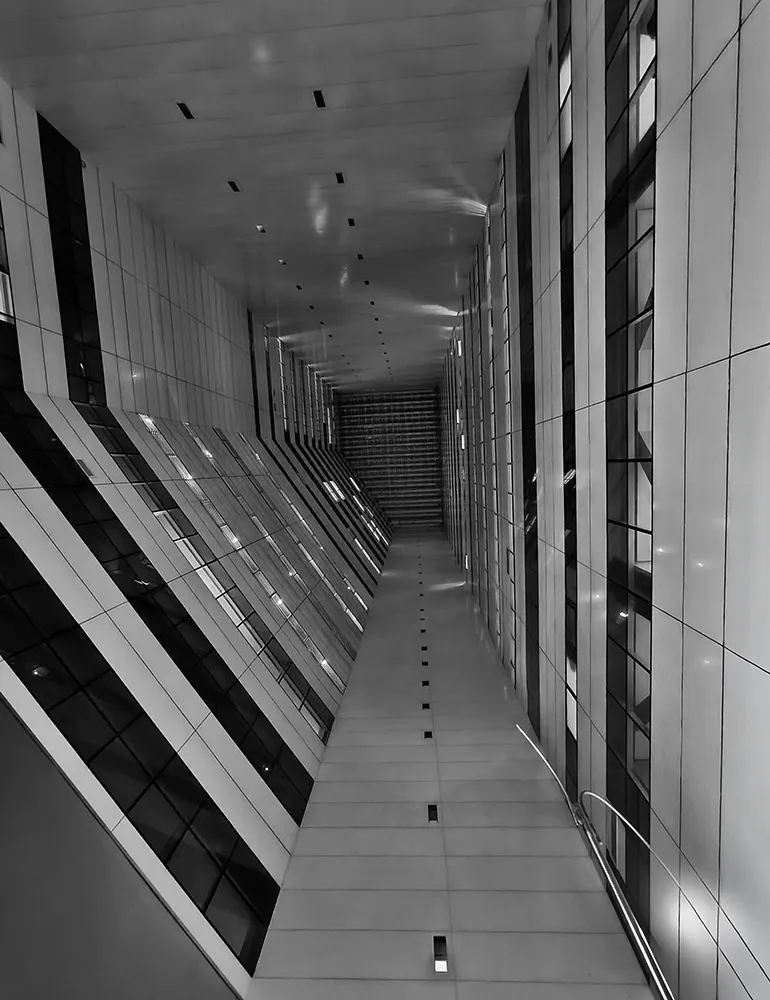 Fotografia em preto e branco de Ricardo Laf registrando uma perspectiva vertical acentuada de uma estrutura de concreto com linhas geométricas paralelas e convergentes na região Centro-Sul de Belo Horizonte.